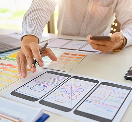 Person working on a mobile app at desk