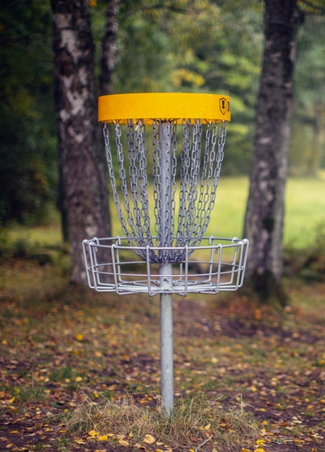 Disc golf basket in the woods