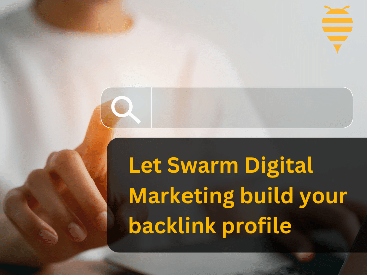 This graphic features a digital marketing team member sitting at his desk on his laptop, pointing at a search bar. This adds emphasis to the overlay text, that advises business owners to let Swarm Digital Marketing build their backlink profile. In the top right is the swarm digital marketing logo.