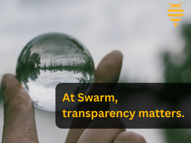 this graphic features a hand holding a see through glass ball. through the ball you can see a lake and trees. There is overlay text drawing attention to the importance of transparency at Swarm Digital Marketing. In the top right is the swarm digital marketing logo.